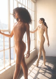 A couple of dancers wearing leotards